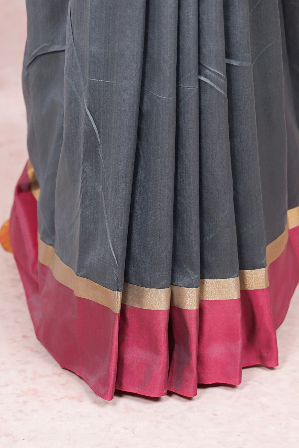 Grey semi silk saree fabric spread, pink and gold border