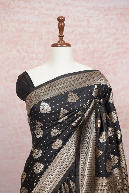 Black satin saree pallu close-up with zari leaf motifs