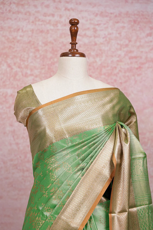 Light green tissue silk saree pallu close-up showing zari work