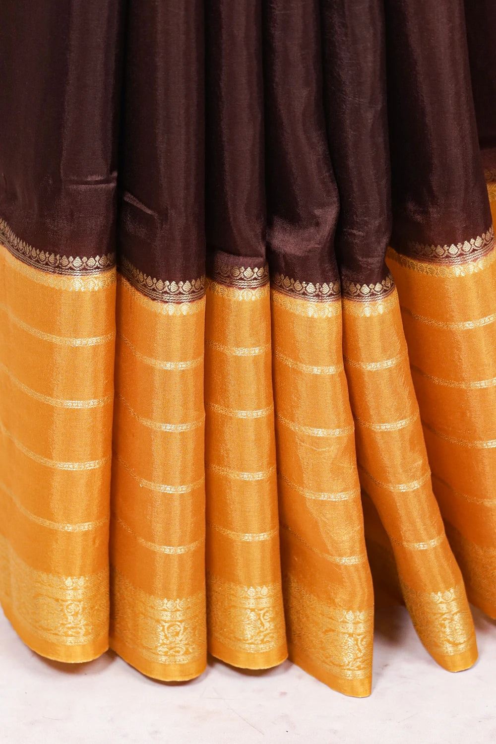 Coffee brown saree pleats with broad golden border