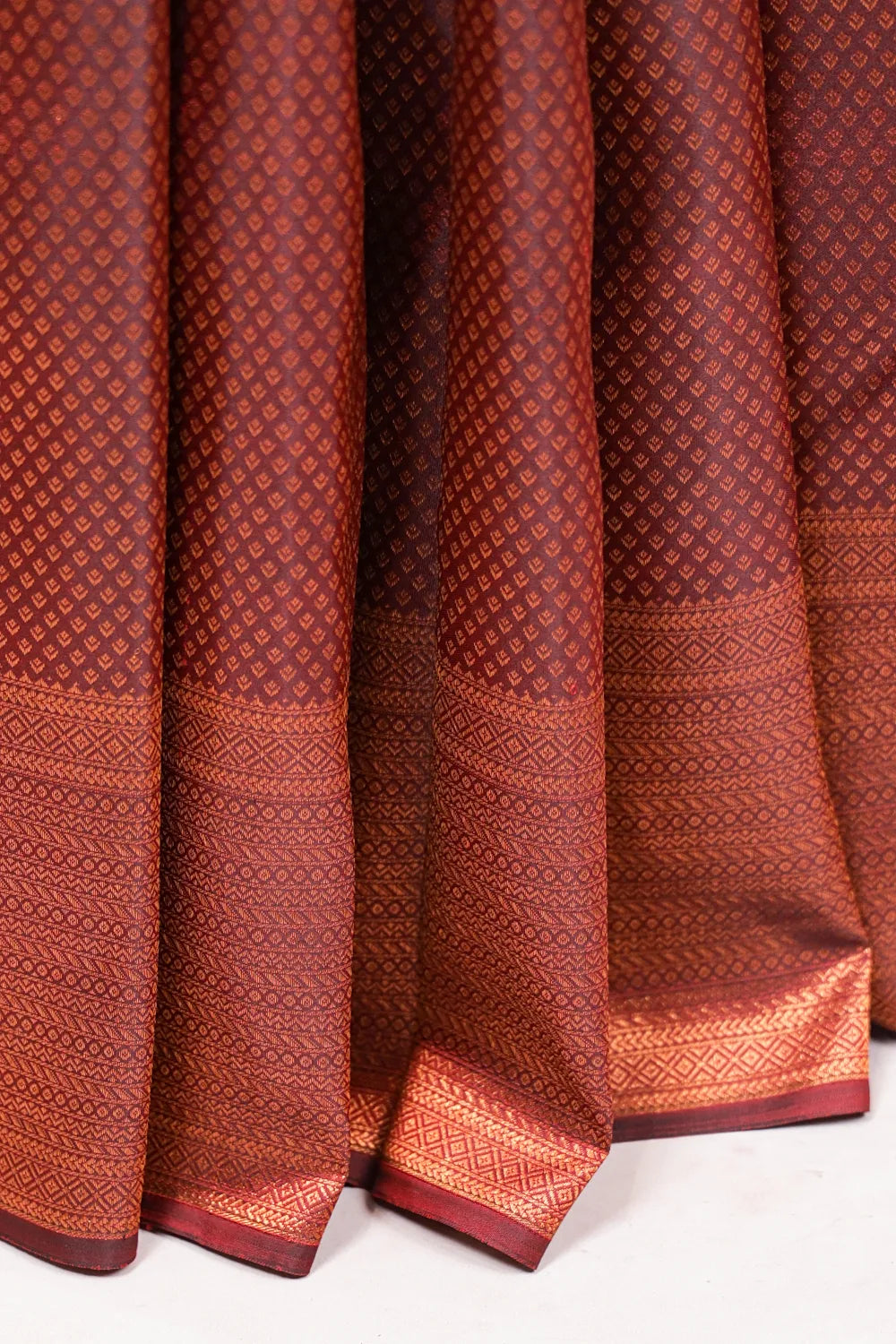 Maroon Kancheepuram Silk Saree fabric spread, designer border detail