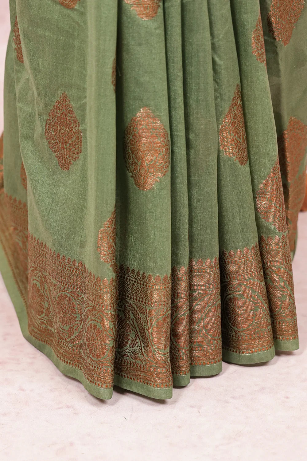 Green Semi Banarasi Saree fabric spread, gold butta motifs and wide border