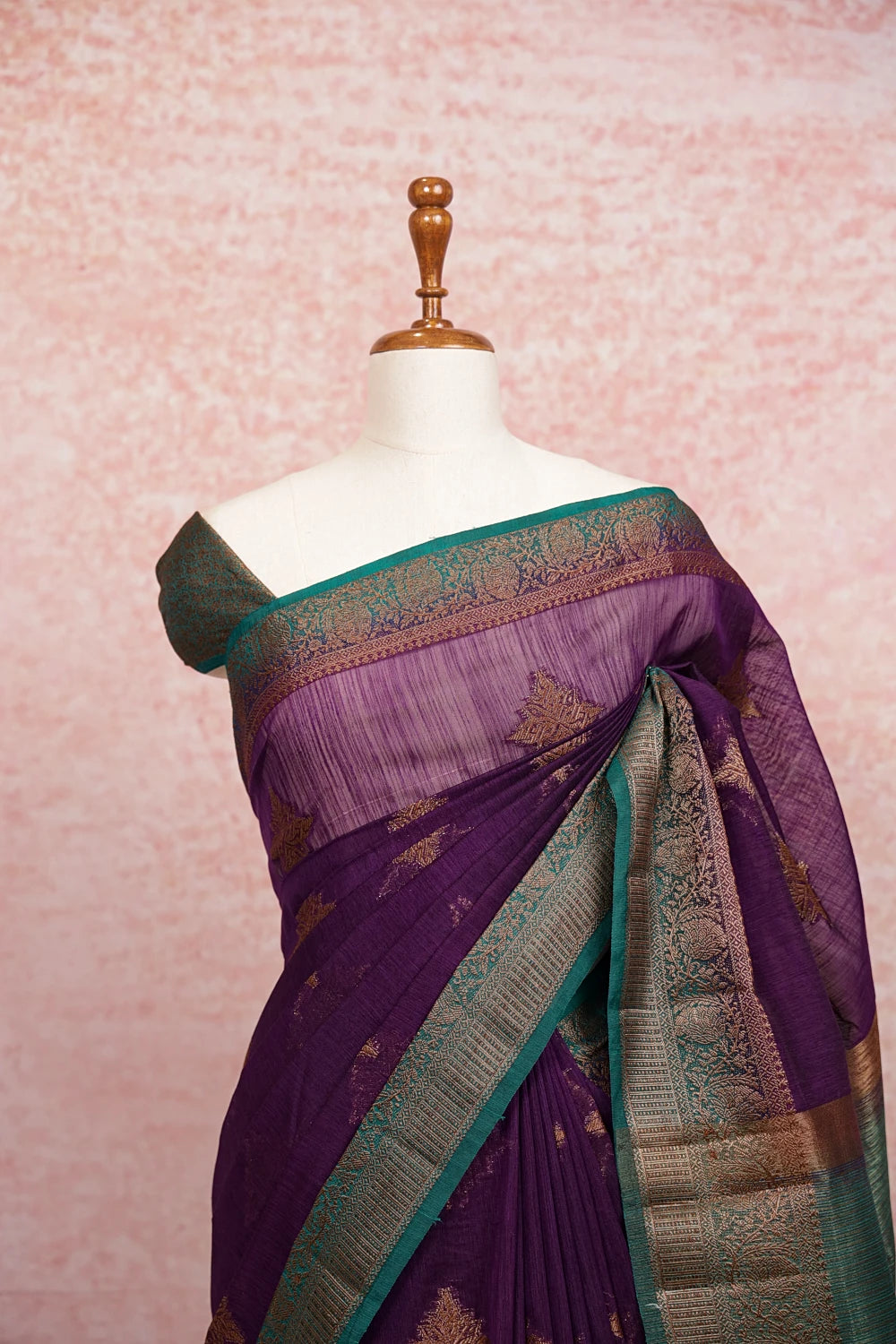 Dark violet jute saree pallu close-up with gold motifs