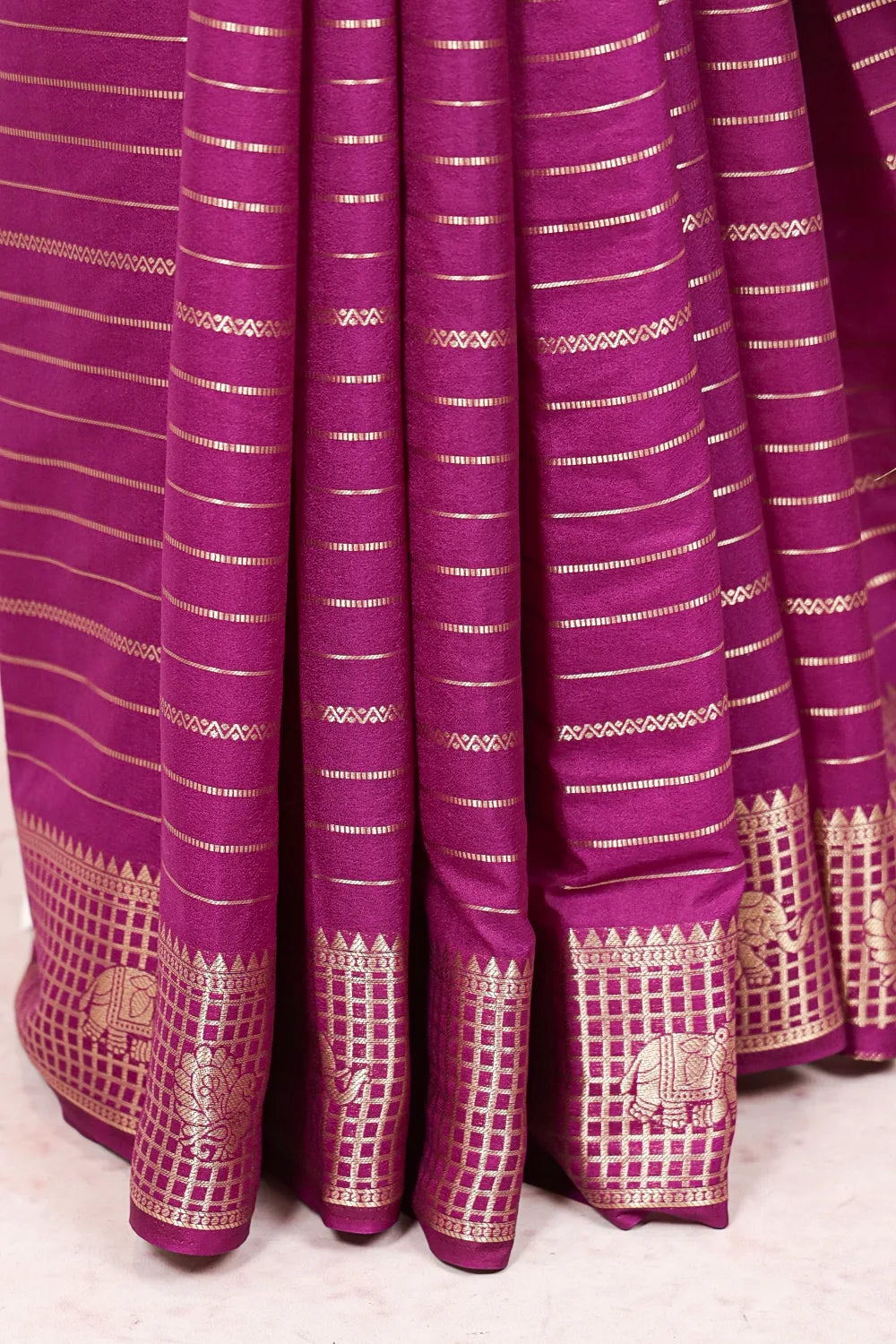 Vadamulla Semi Banarasi Saree wide gold patterned border, magenta silk fabric spread