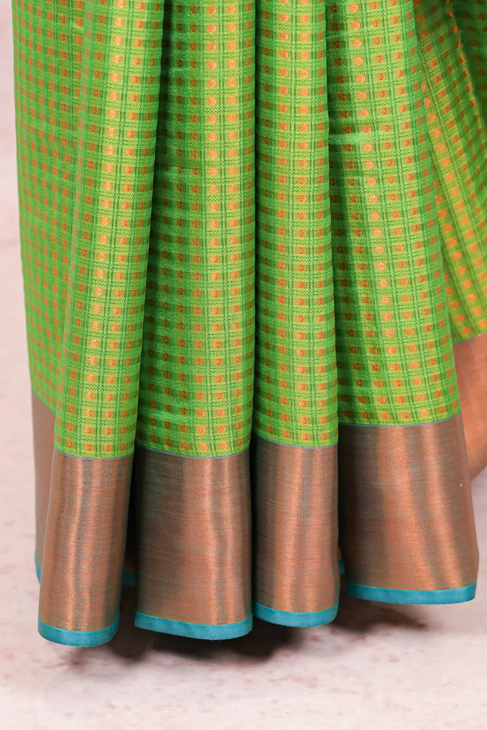 Parrot Green Semi Silk Saree fabric spread, brocade weave with copper border