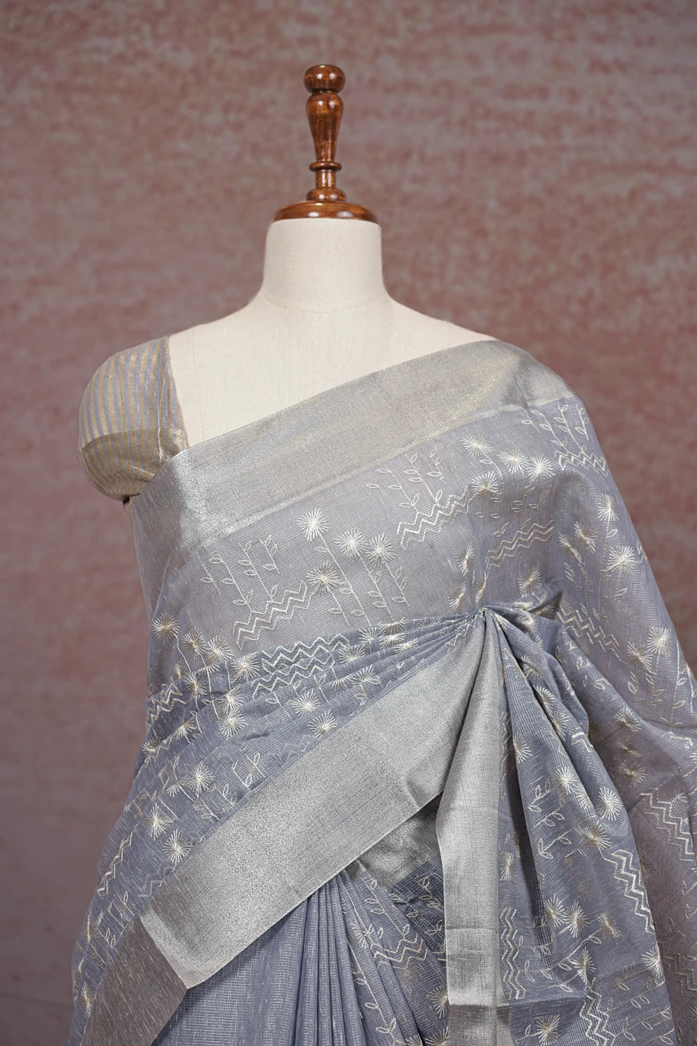 Close-up of ash kota saree pallu showing silver thread embroidery detailing - Seematti