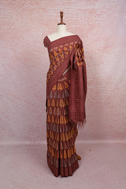 Brown cotton saree with leaf print, draped on mannequin - Seematti