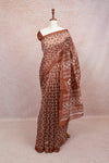 Brown semi jute saree with white block-print motifs draped on mannequin, without border