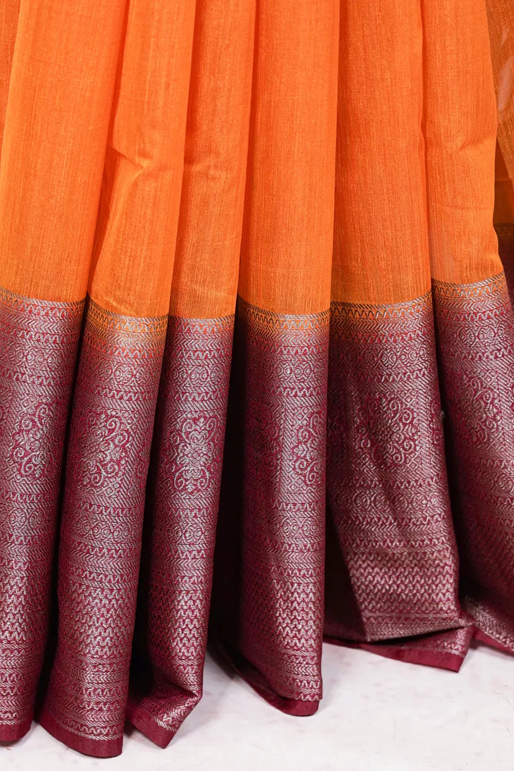 Mango yellow semi jute saree fabric spread, paisley zari border