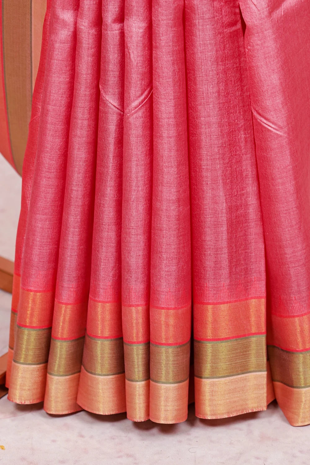 Dark pink tussar silk saree fabric spread, striped border detail