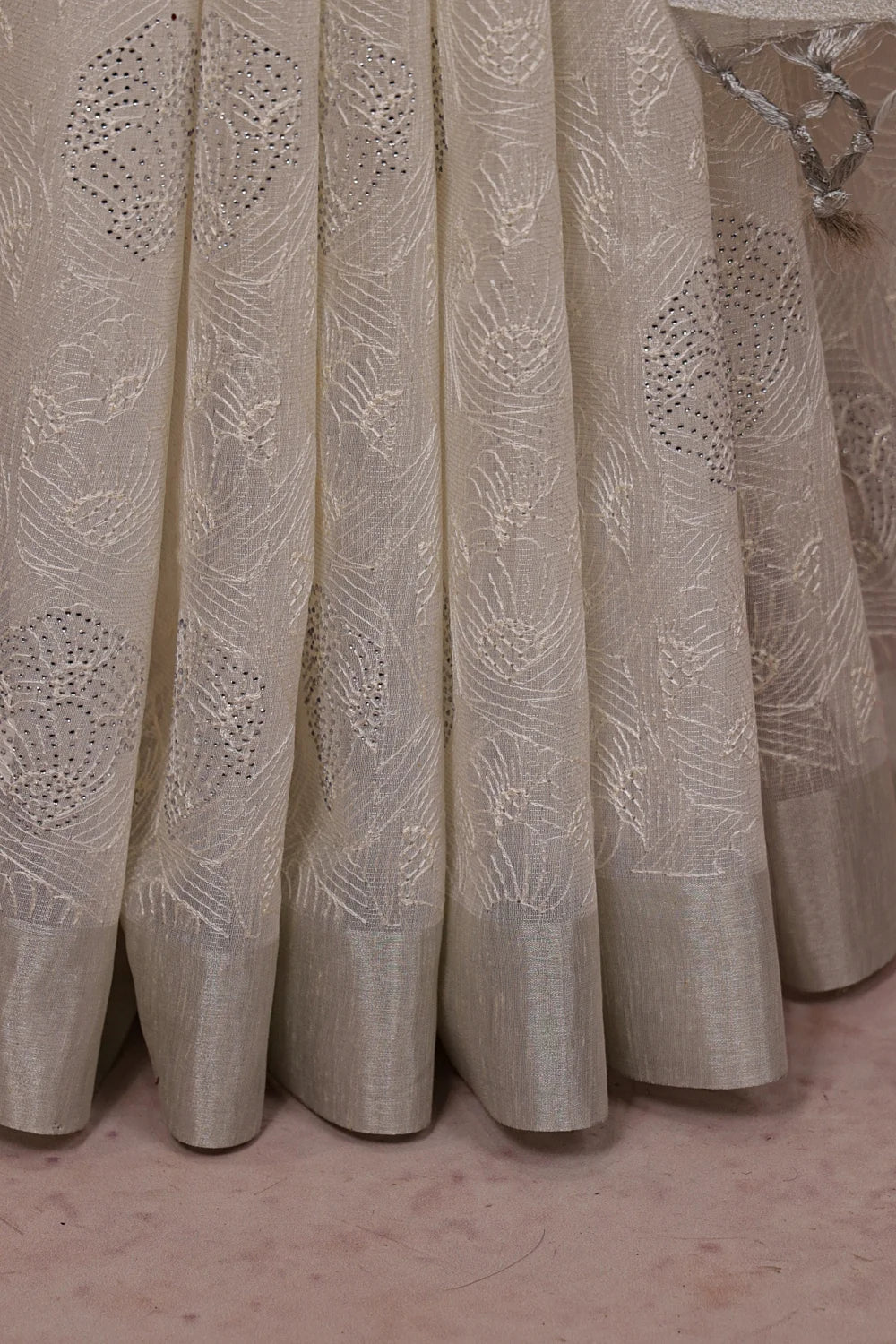 Silver Semi Tissue Saree fabric spread, silver border and stone work detail