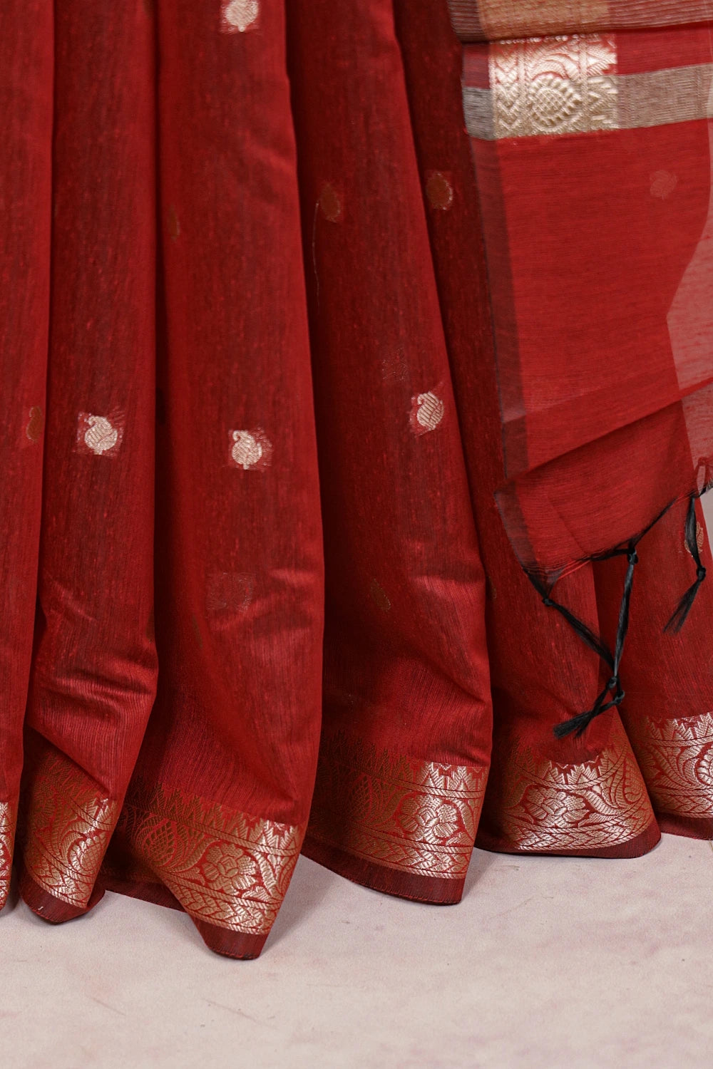 Maroon cotton silk saree fabric spread, designer border detail