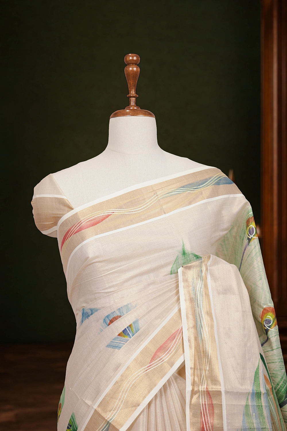 Kerala saree pallu close-up with painted feather motif
