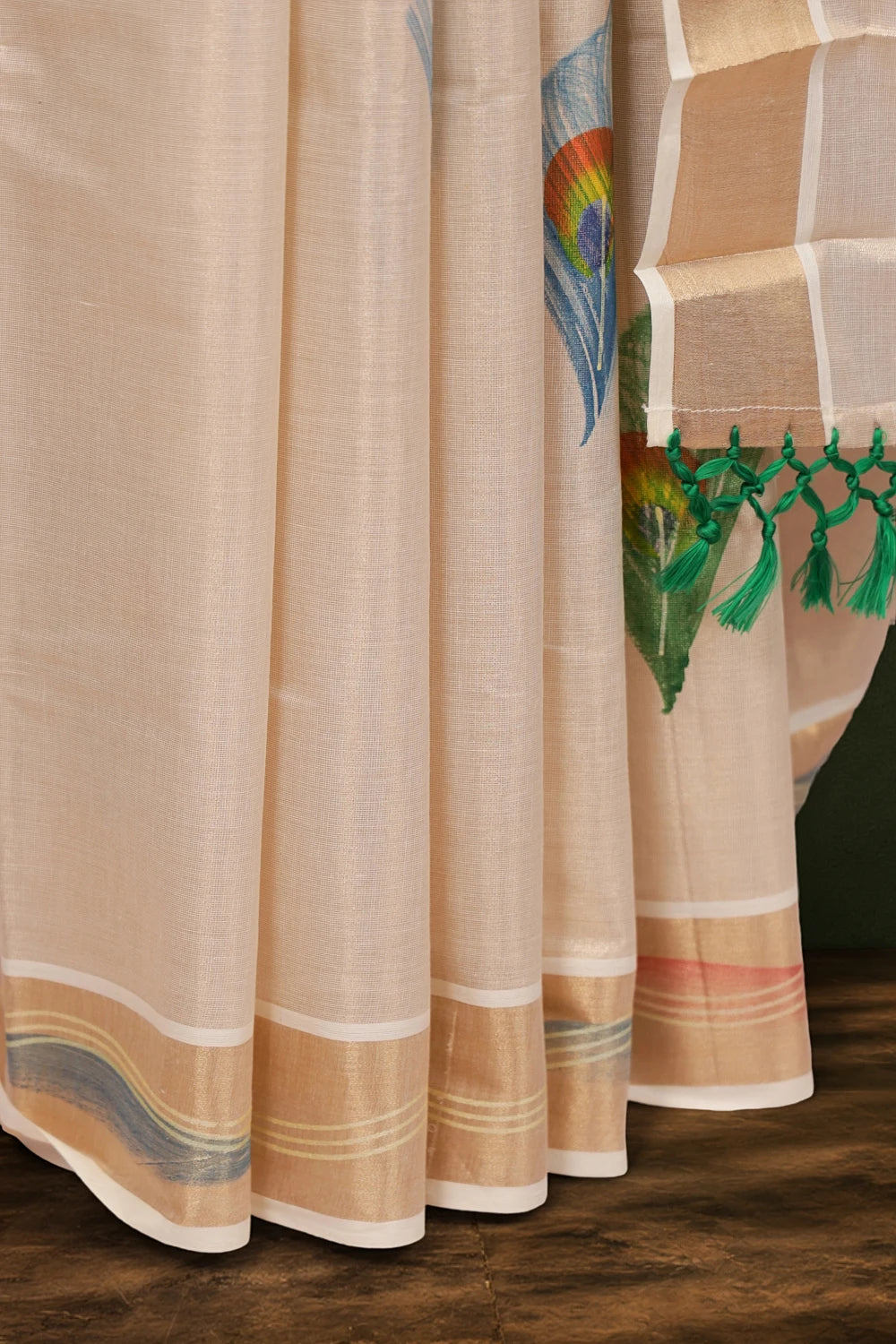 Golden tissue saree fabric detail, hand-painted peacock feather