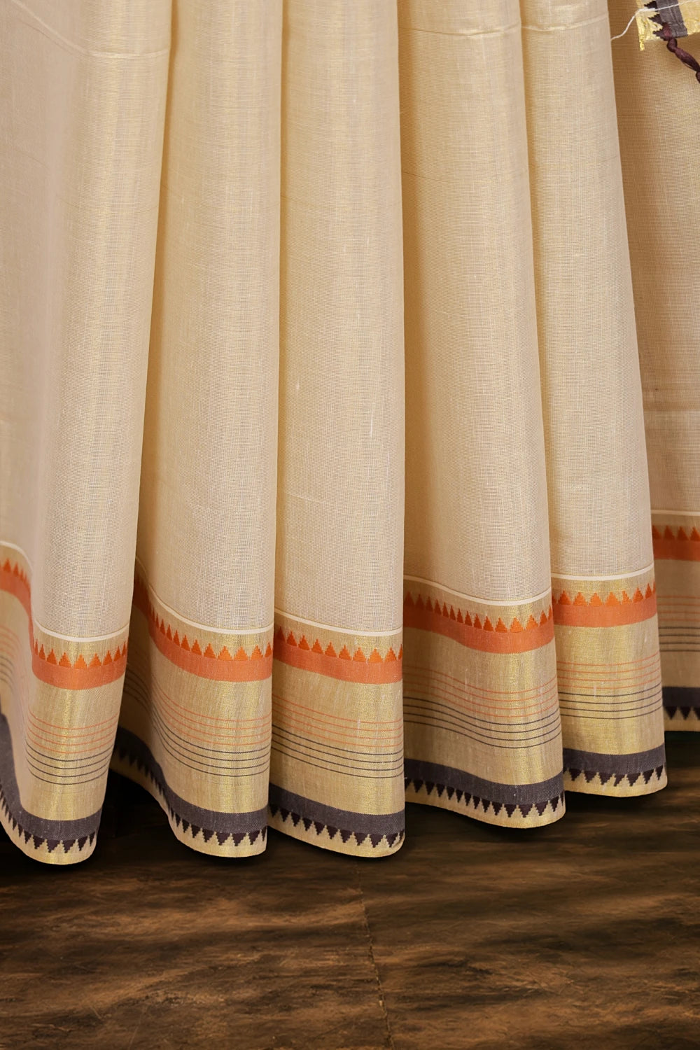 Golden tissue saree border detail, black and orange lines