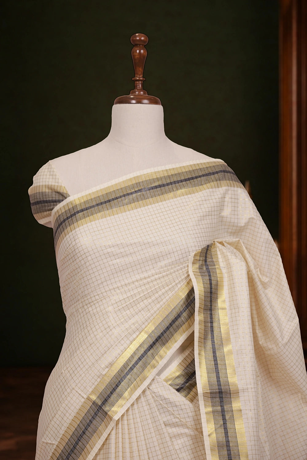 Off white Kerala saree pallu close-up with striped border
