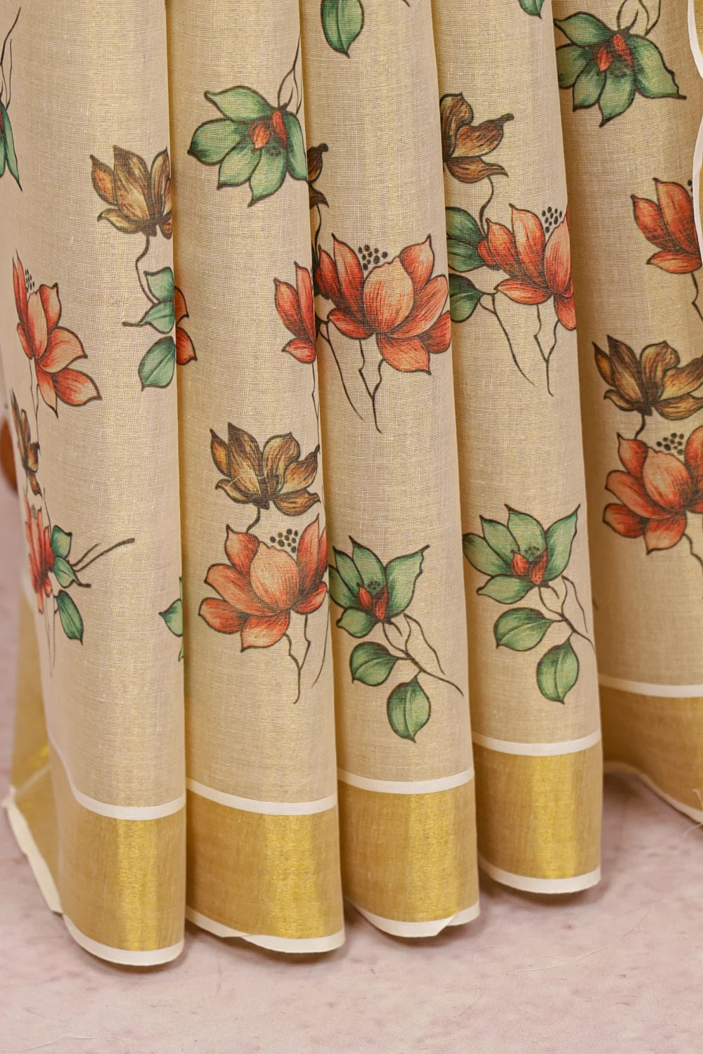 Golden Tissue Kerala Saree fabric spread, floral vine border design