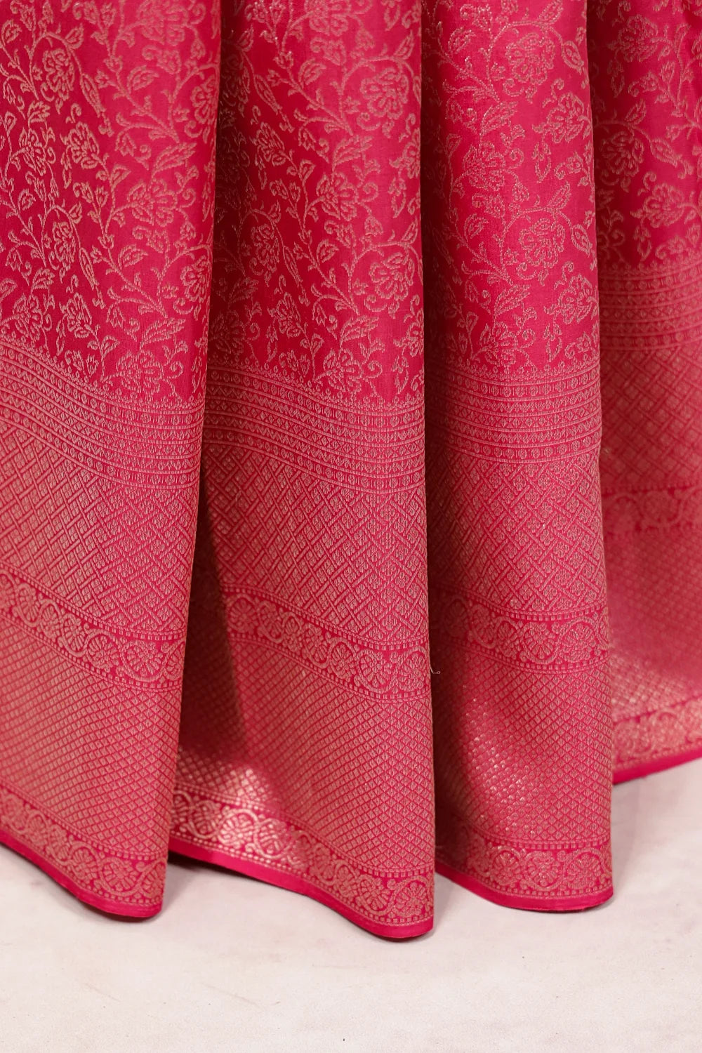 Pink Kancheepuram Silk Saree fabric spread, designer border detail