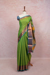 Parrot Green Semi Silk Saree with copper border, draped on mannequin - Seematti
