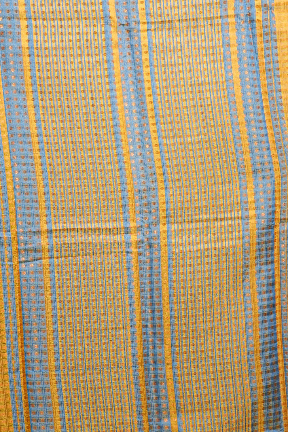 Semi silk saree fabric texture with copper-toned border detail