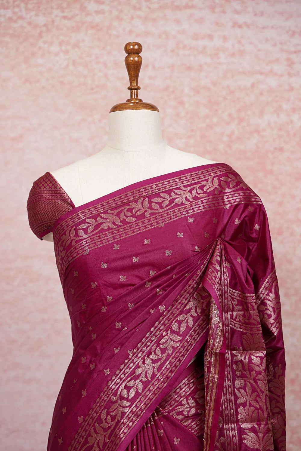 Wine Banarasi saree pallu close-up with gold butta motifs